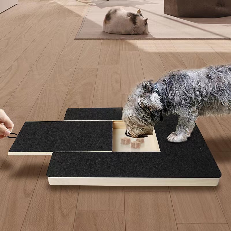 Dog filing its nails on the PawFile scratch board while eating treats from the built-in treat box